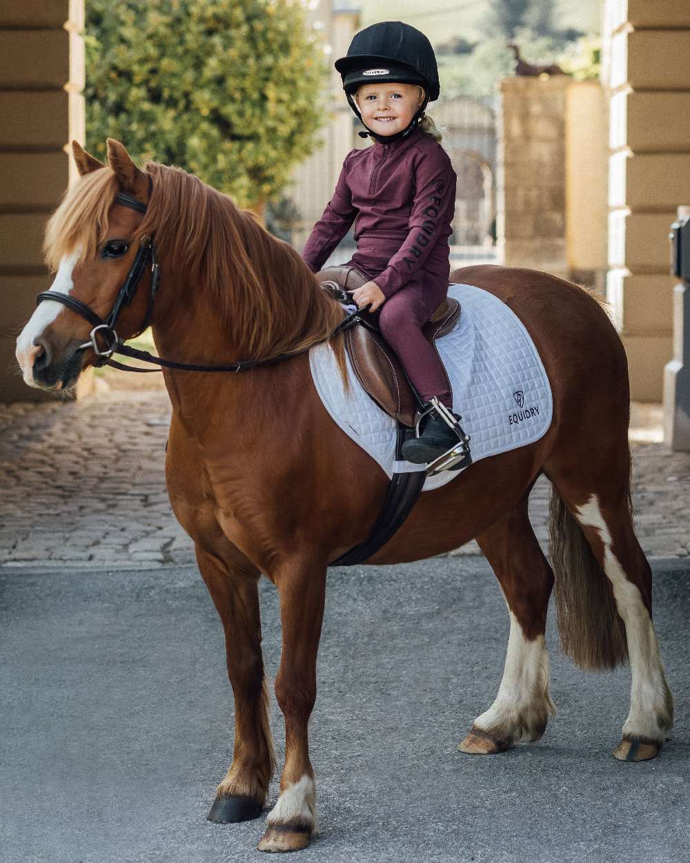Plum Black Coloured Equidry Childrens Water Repellent Full Seat Leggings on outdoor background