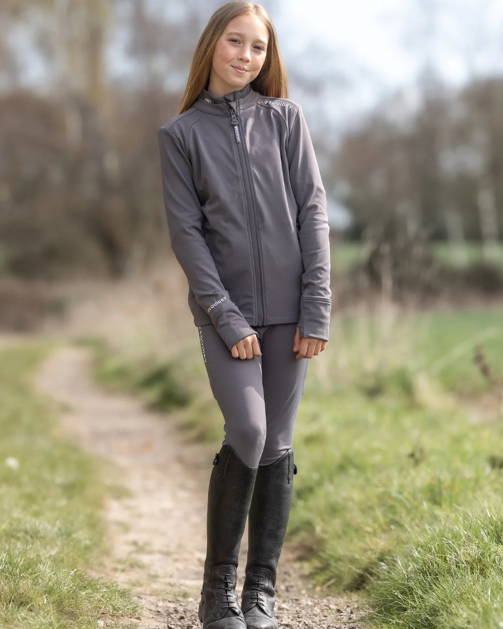 Grey White Coloured Equidry Childrens Water Repellent Zip Up Top on outdoor background