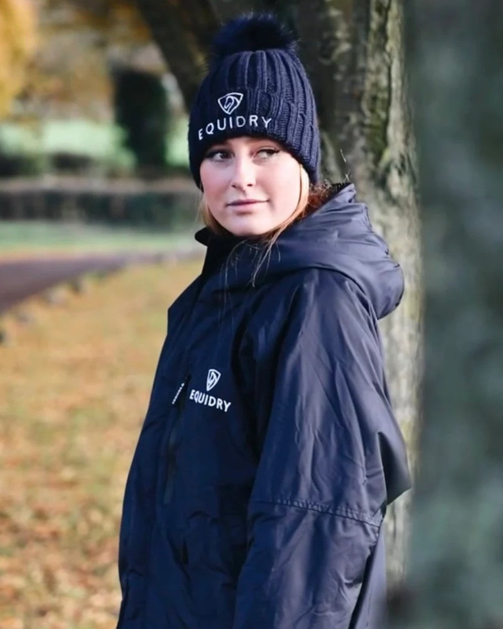 Navy coloured Equidry Chunky Pom Pom Bobble Hat on tree background