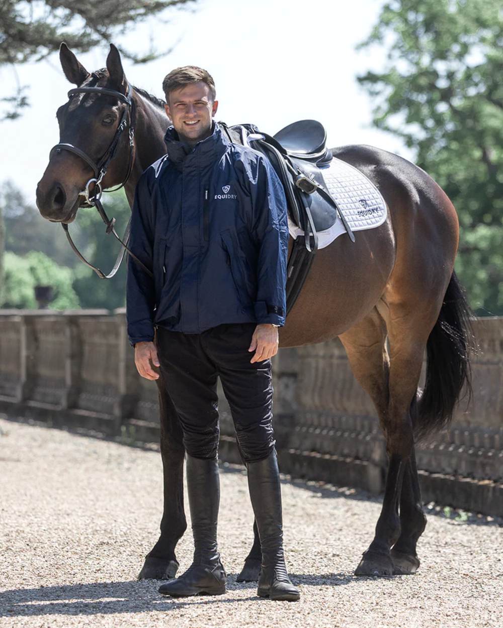 Navy coloured Equidry Mens Equimac Shortie With Stowaway Hood on outdoor background