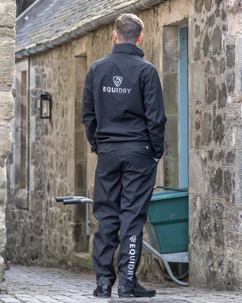 Black coloured Equidry Mens Fleece Lined Waterproof Trousers on outdoor background