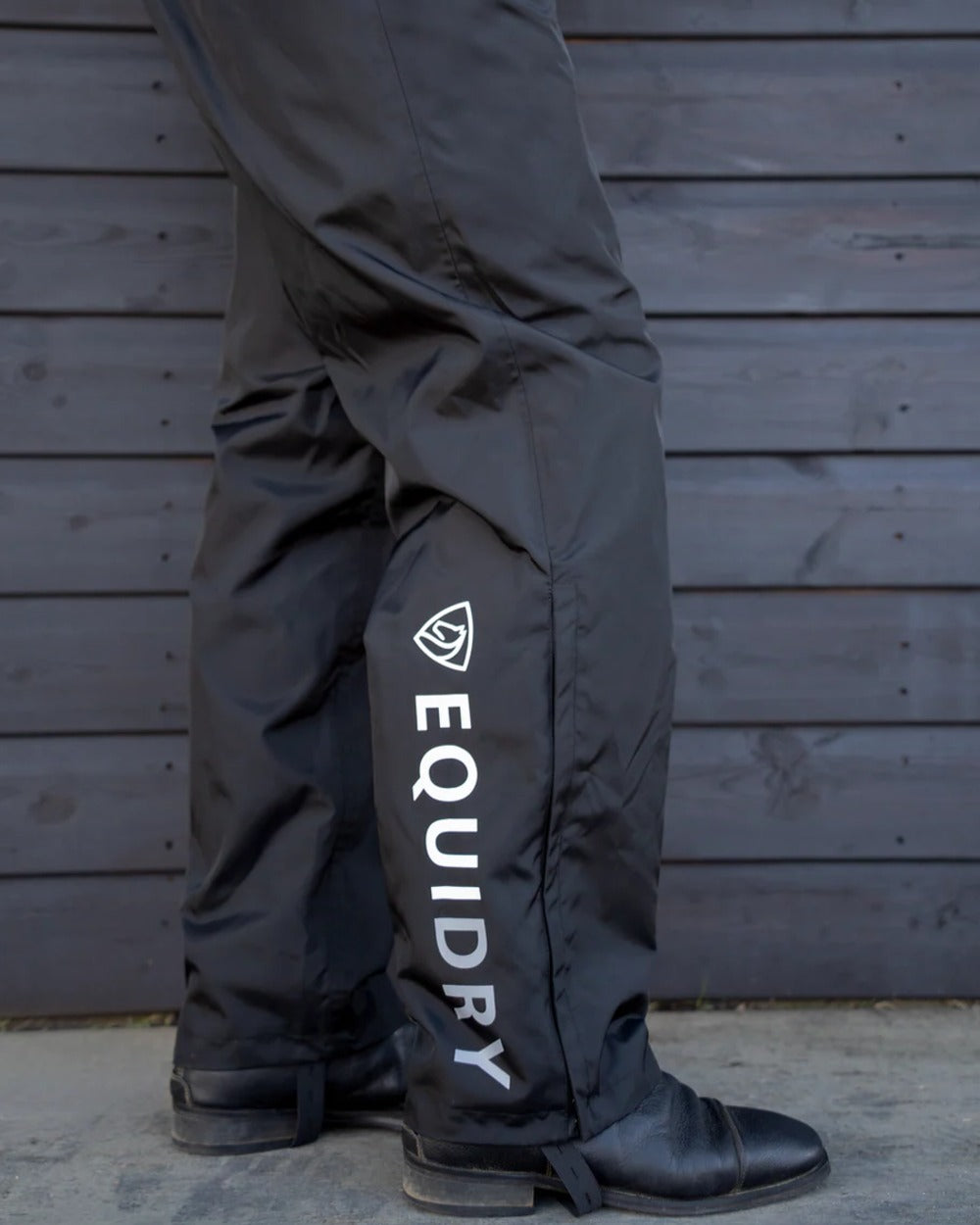 Black coloured Equidry Mens Fleece Lined Waterproof Trousers on outdoor background