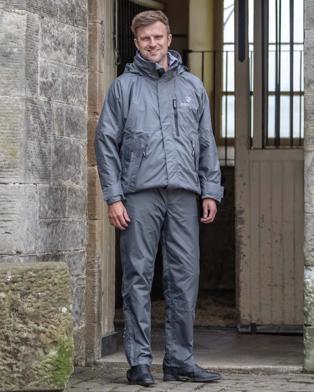 Charcoal coloured Equidry Mens Fleece Lined Waterproof Trousers on outdoor background