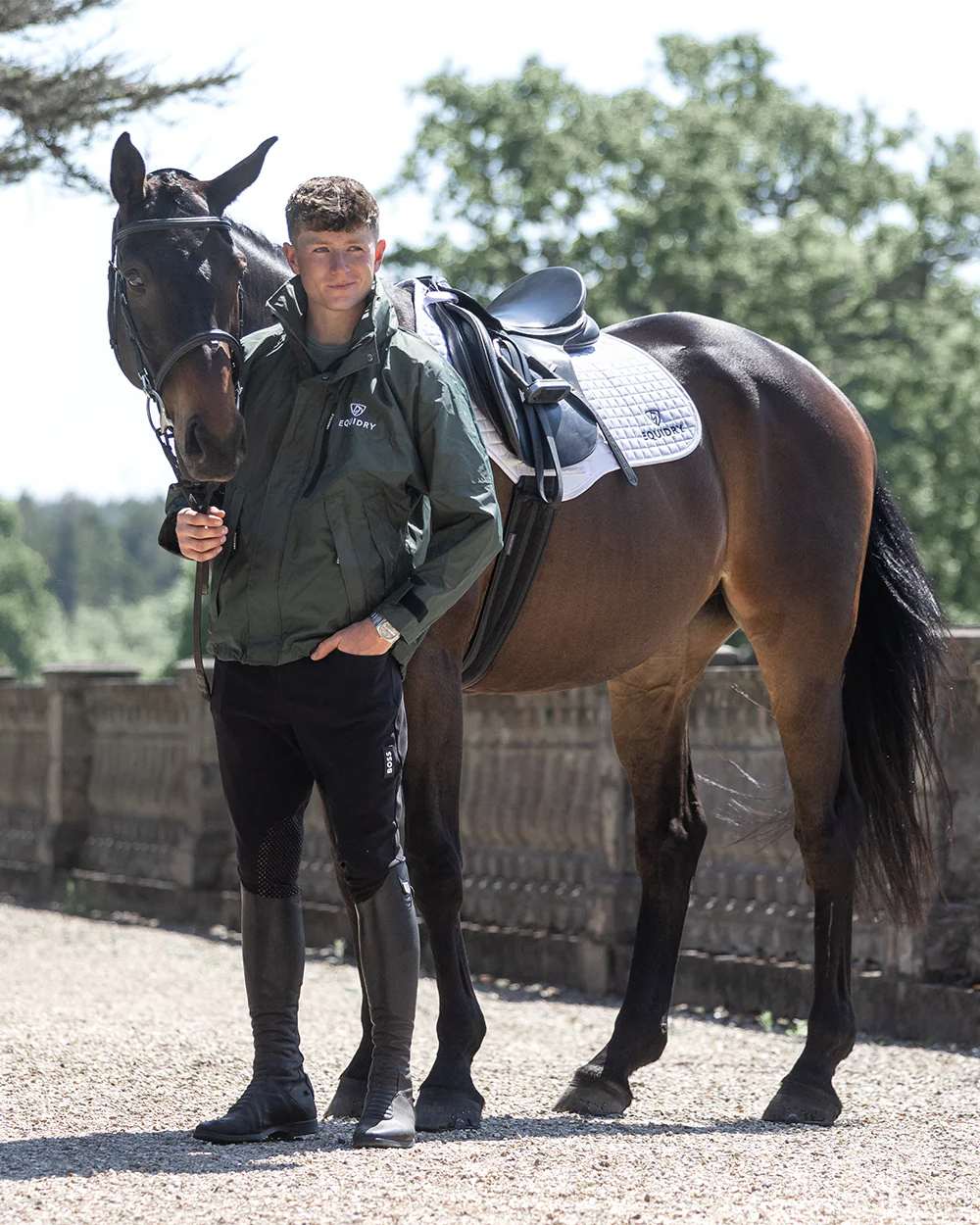 Black Forest Green coloured Equidry Mens Equimac Shortie With Stowaway Hood on street background