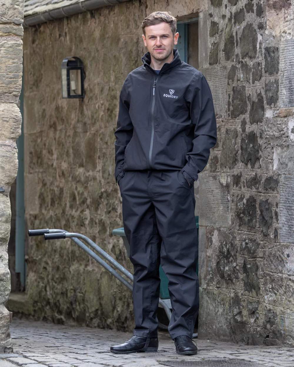 Black coloured Equidry Mens Unlined Waterproof Trousers on outdoor background