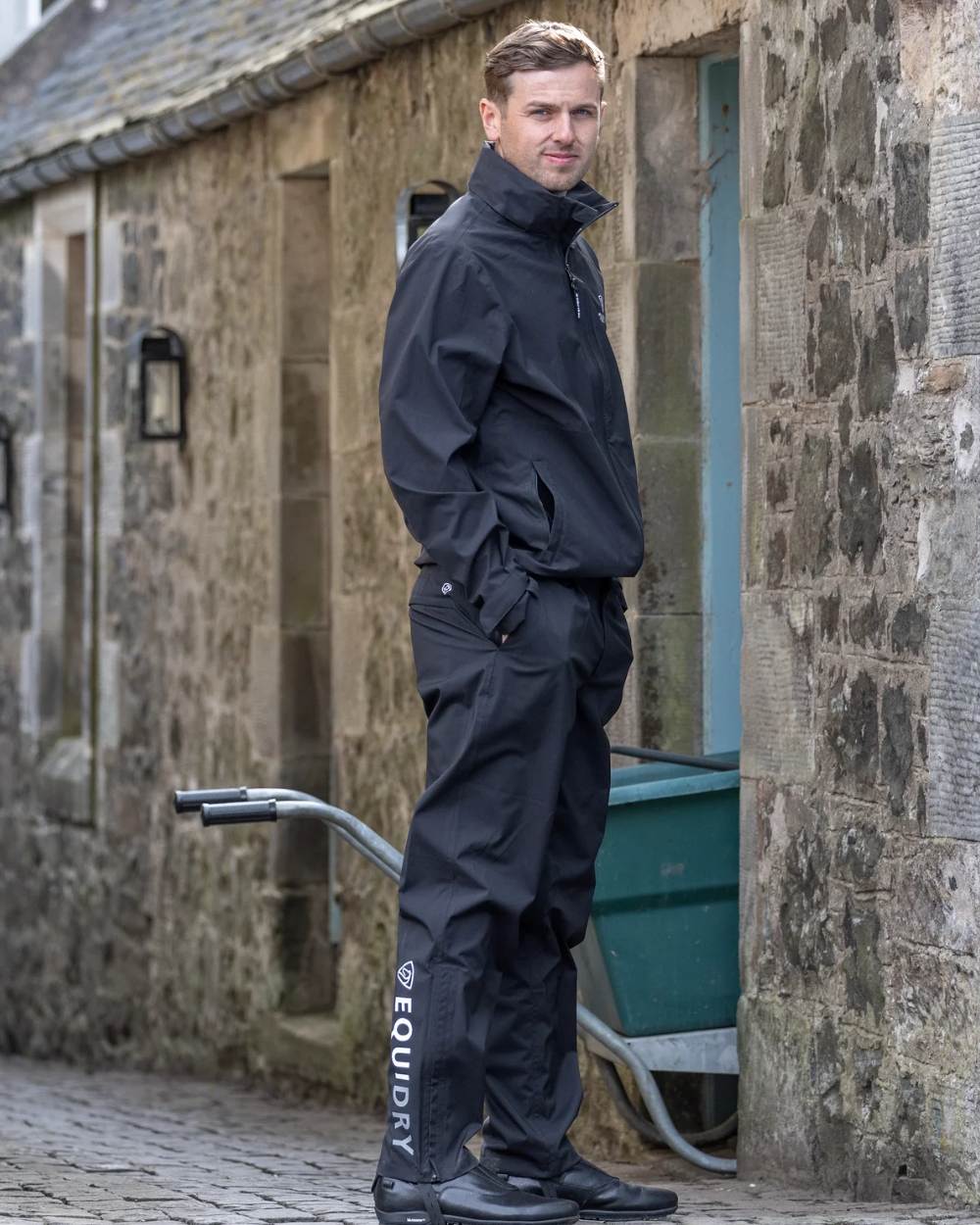 Black coloured Equidry Mens Unlined Waterproof Trousers on outdoor background
