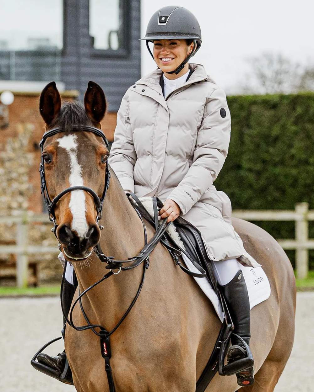 Taupe coloured Equidry Thora Waterproof Riding Puffer Coat With Hood on outdoor background