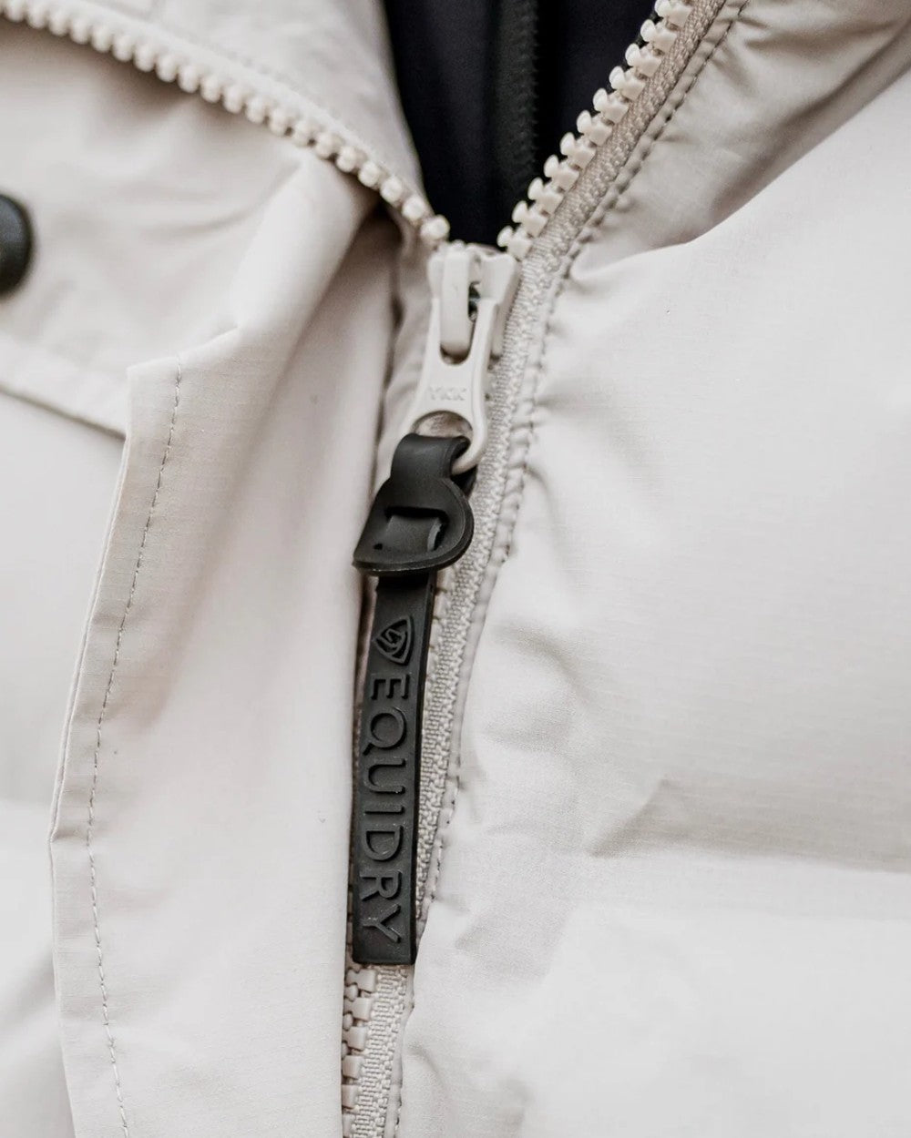 Taupe coloured Equidry Thora Waterproof Riding Puffer Coat With Hood on outdoor background
