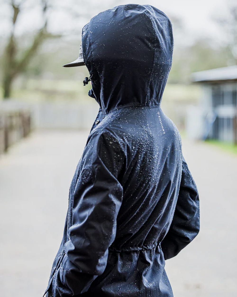 Navy coloured Equidry Womens Bronte Riding Coat on outdoor background