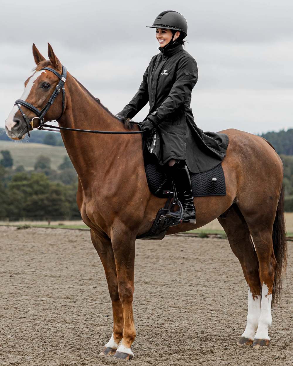 Black Coloured Equidry Womens Bronte Riding Coat With Removable Hood on outdoor background
