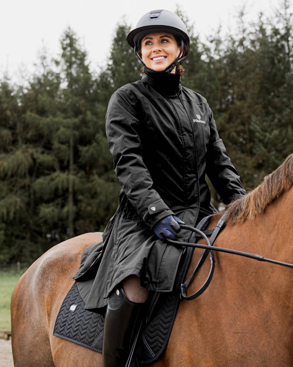 Black Coloured Equidry Womens Bronte Riding Coat With Removable Hood on outdoor background