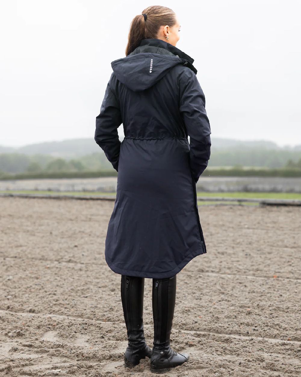 Navy Coloured Equidry Womens Bronte Riding Coat With Removable Hood on outdoor background