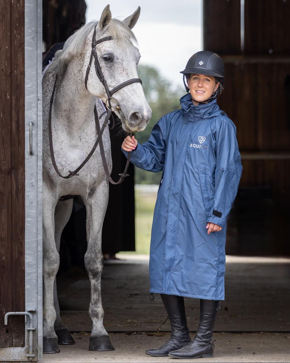 Steel Blue Navy coloured Equidry Womens Equimac Evolution Jacket on stable background