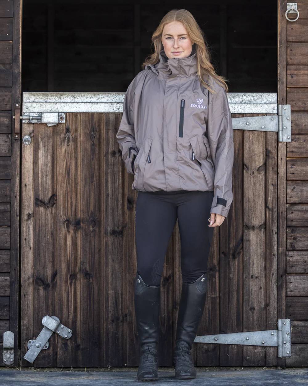 Mocha coloured Equidry Womens Equimac Shortie With Stowaway Hood on outdoor background