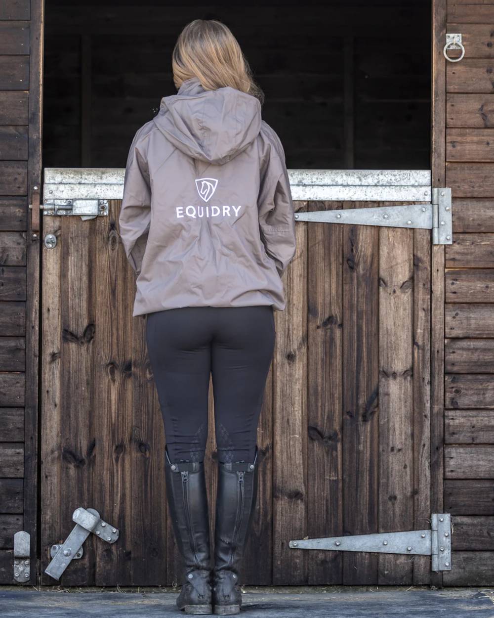 Mocha coloured Equidry Womens Equimac Shortie With Stowaway Hood on outdoor background