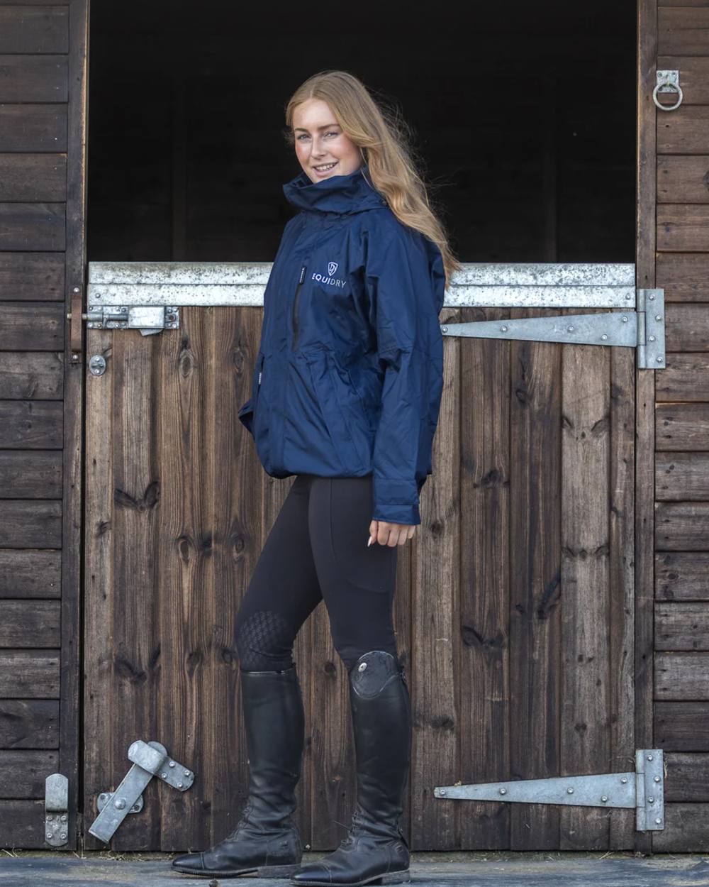 Navy coloured Equidry Womens Equimac Shortie With Stowaway Hood on outdoor background