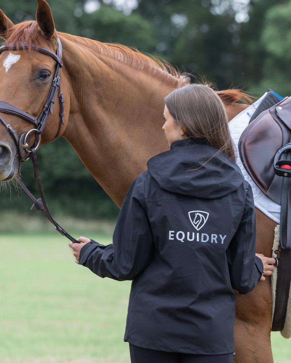 Black coloured Equidry Womens Nimbus Pack Away Jacket with Stowaway Hood on street background