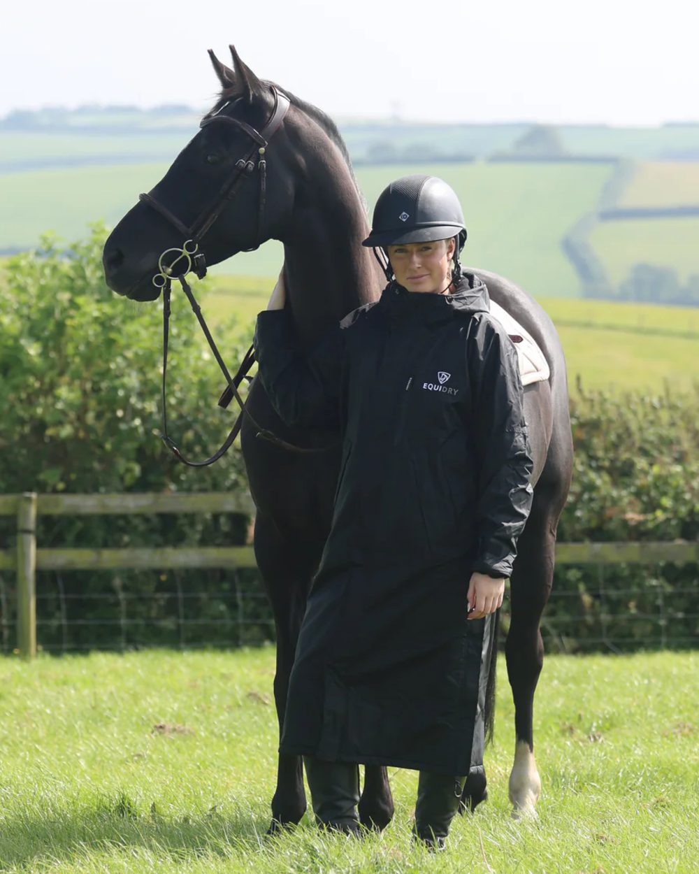 Black coloured Equidry Womens Pro Ride Evolution Thin Fleece Coat With Stowaway Hood on outdoor background