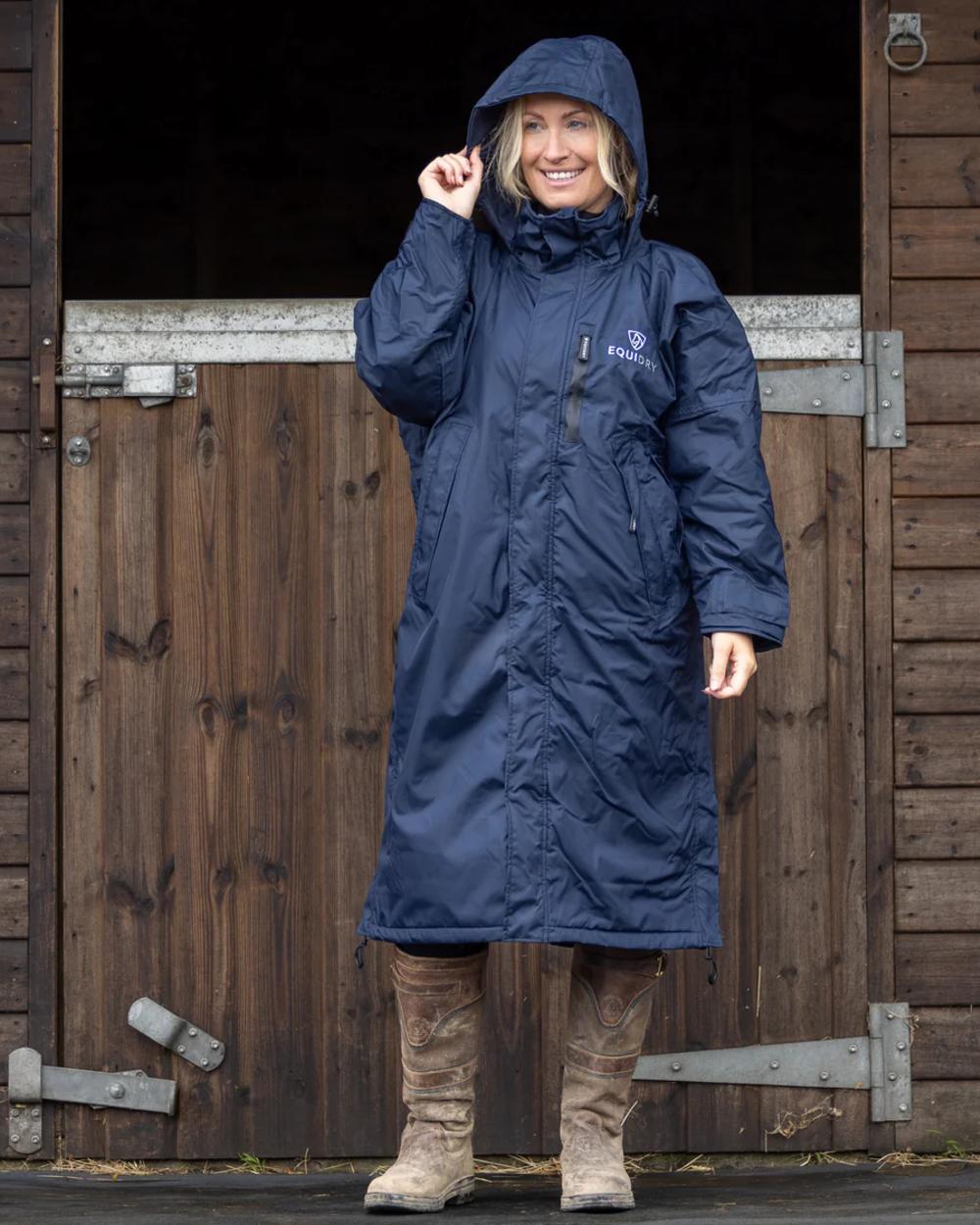 Navy coloured Equidry Womens Pro Ride Evolution Thin Fleece Coat With Stowaway Hood on outdoor background