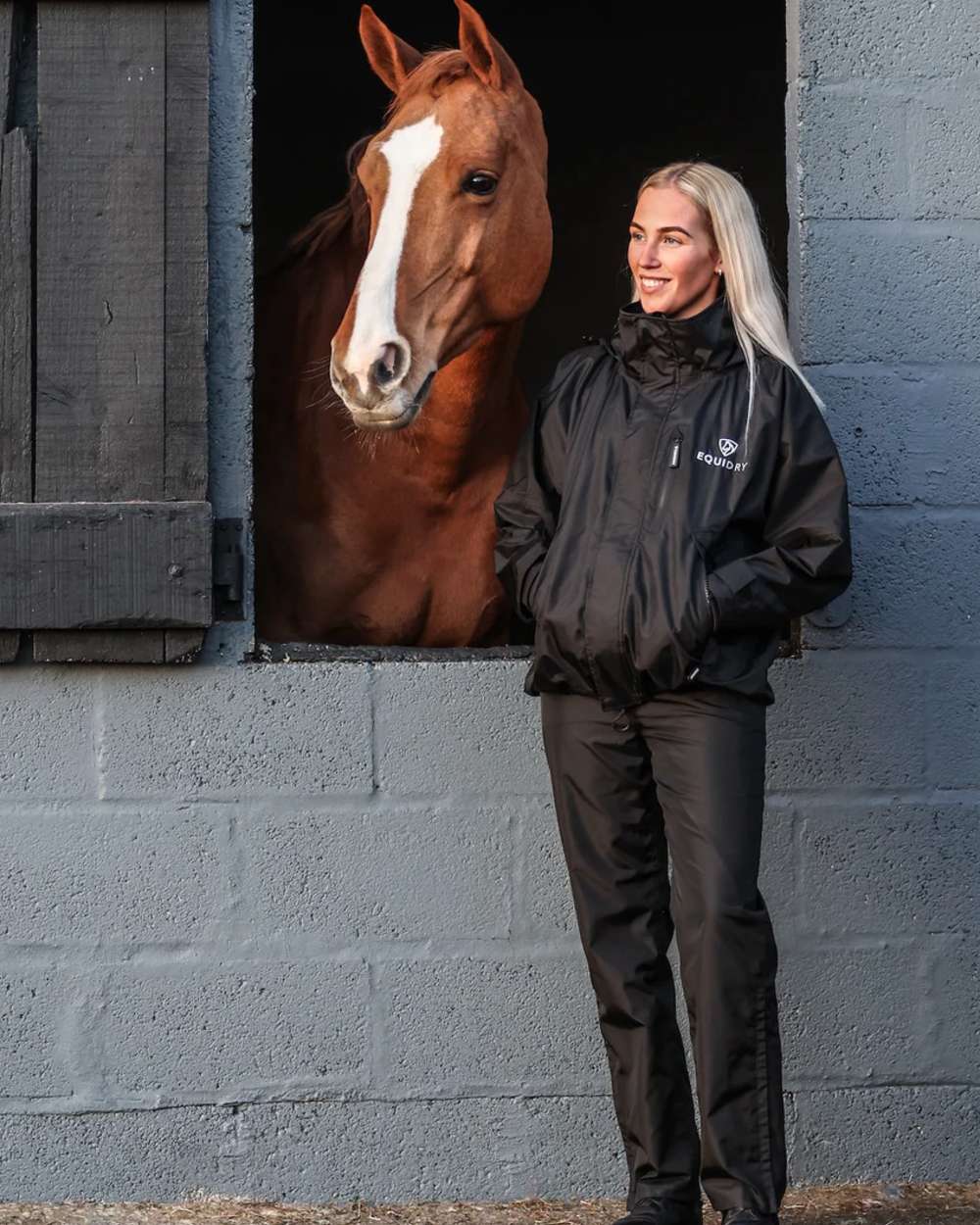 Black coloured Equidry Womens Shortie Thin Fleece Jacket With Stowaway Hood on outdoor background