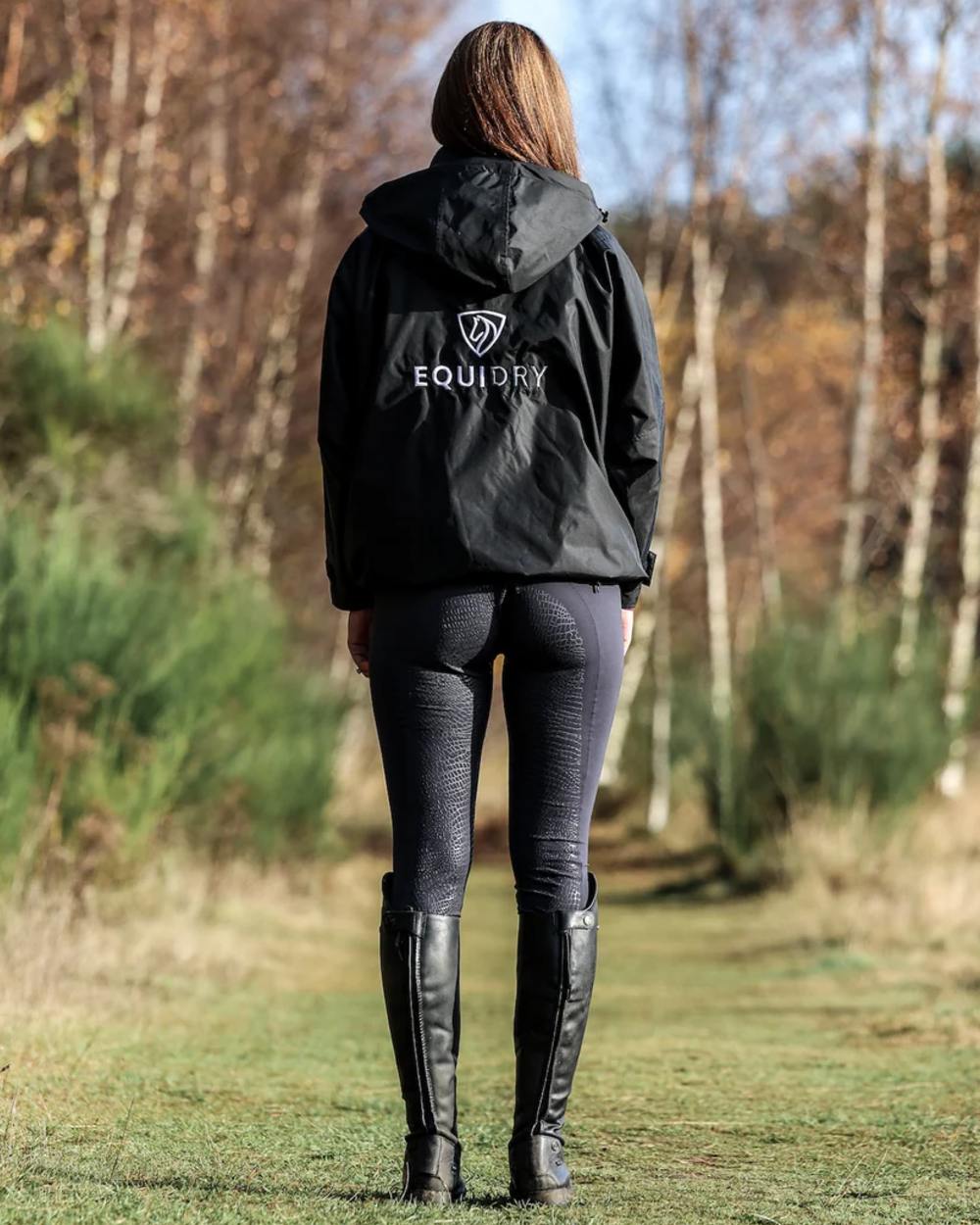 Black coloured Equidry Womens Shortie Thin Fleece Jacket With Stowaway Hood on outdoor background