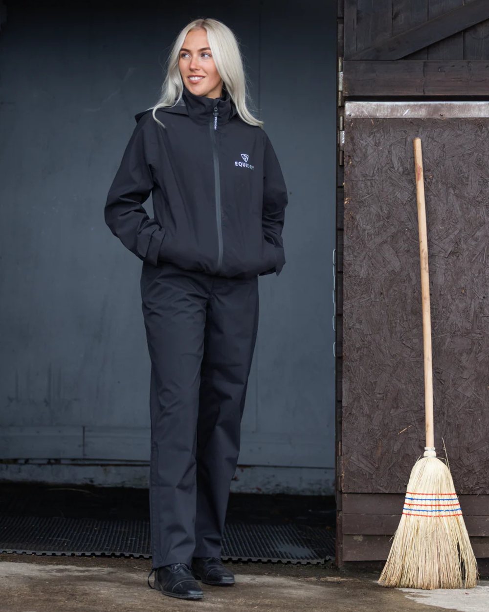 Black coloured Equidry Womens Unlined Waterproof Trousers on outdoor background