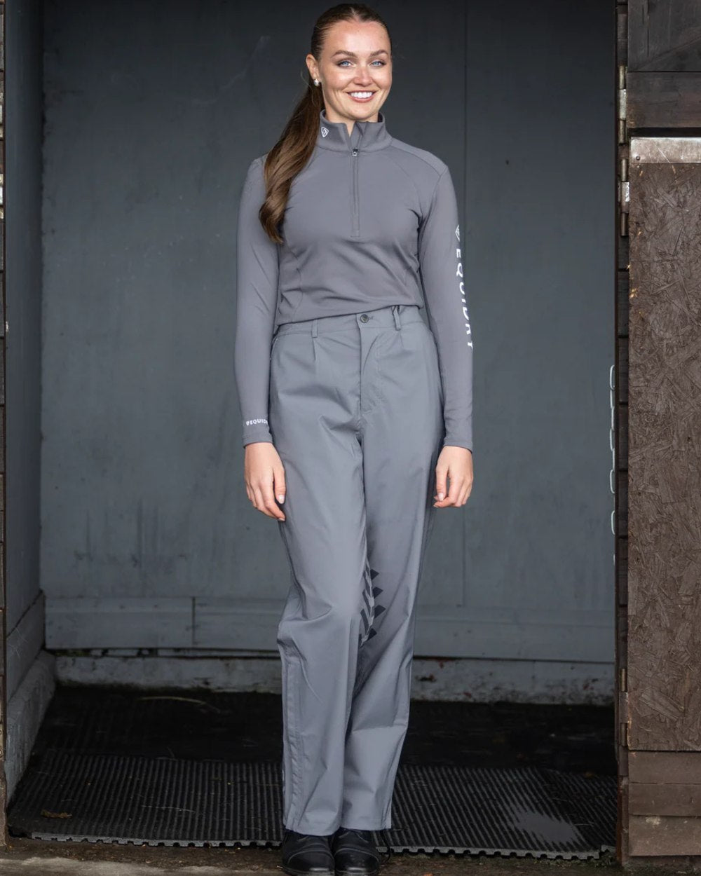 Charcoal coloured Equidry Womens Unlined Waterproof Trousers on outdoor background