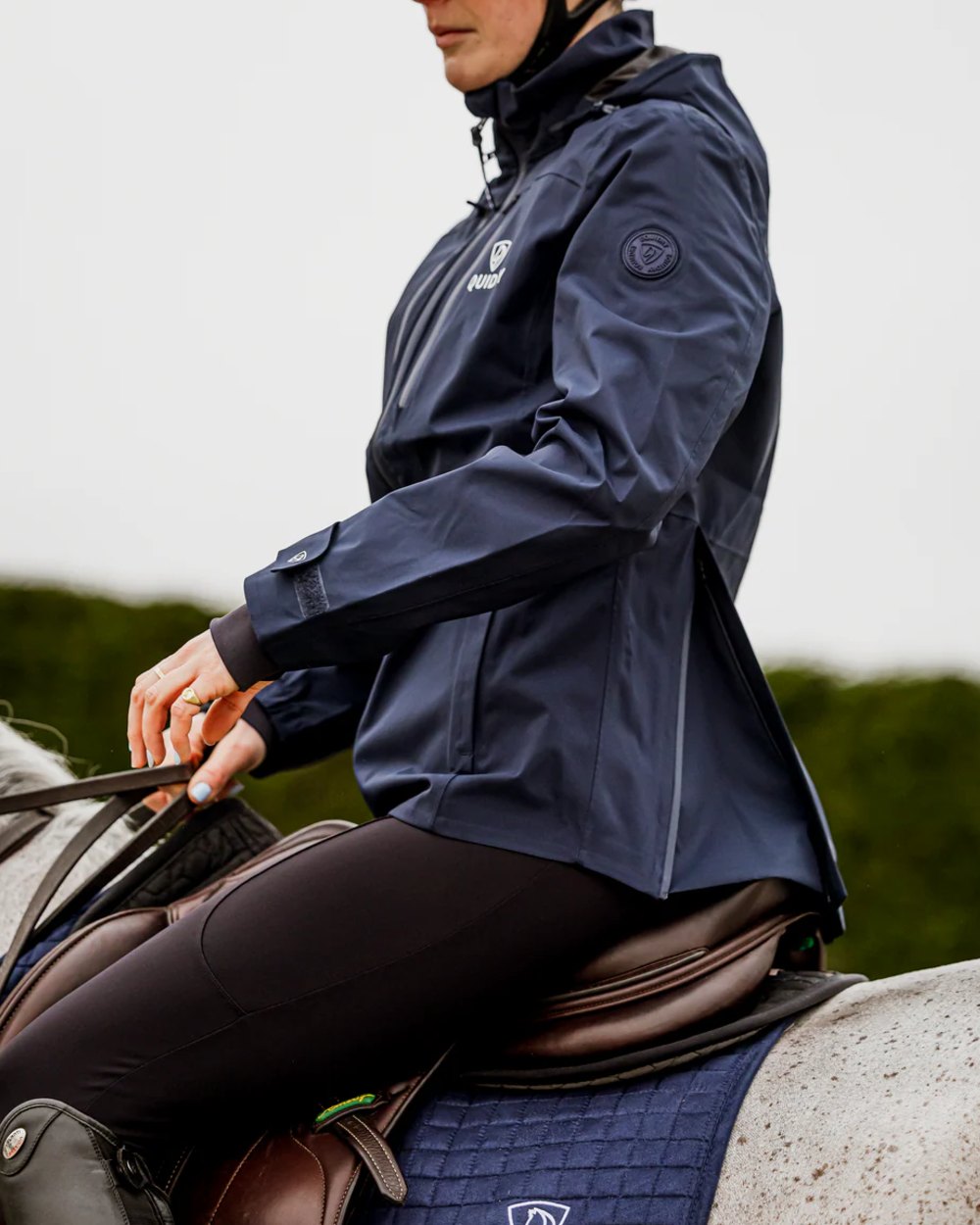 Navy coloured Equidry Womens Varsha Jacket with Stowaway Hood on outdoor background