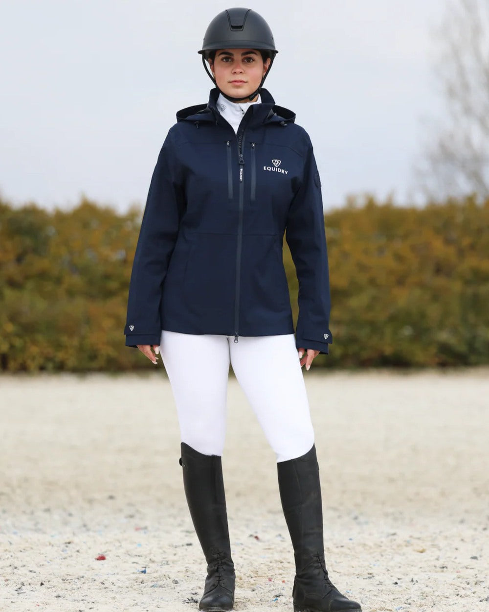 Navy coloured Equidry Womens Varsha Jacket with Stowaway Hood on sand background