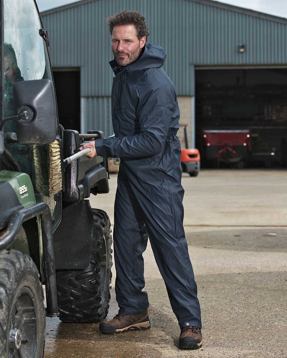 Navy coloured Fort Fortex Flex Coverall on work shed background
