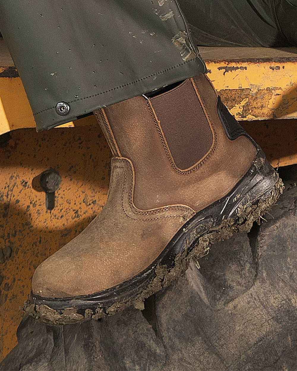 Brown coloured Fort Regent Safety Boots on yellow background