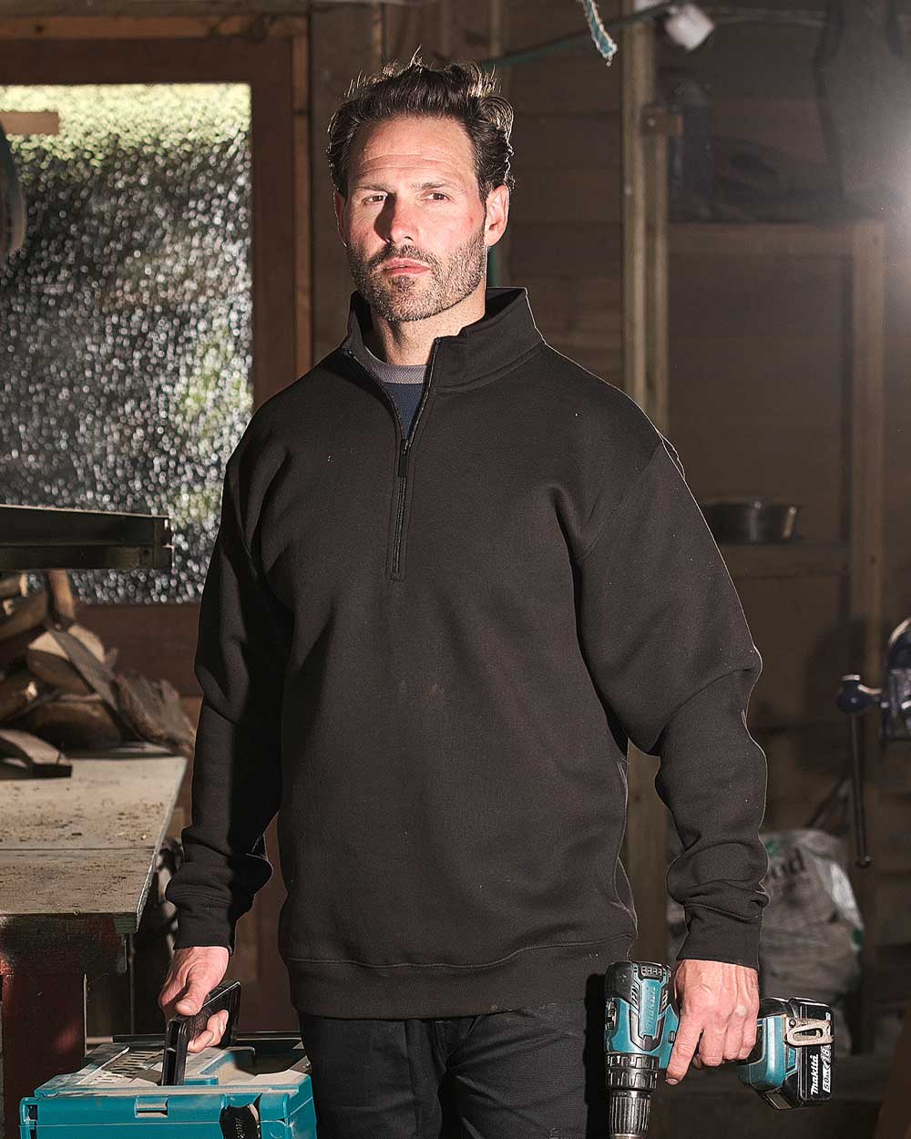 Man working in Black Fort Workforce Quarter Zip Sweatshirt 