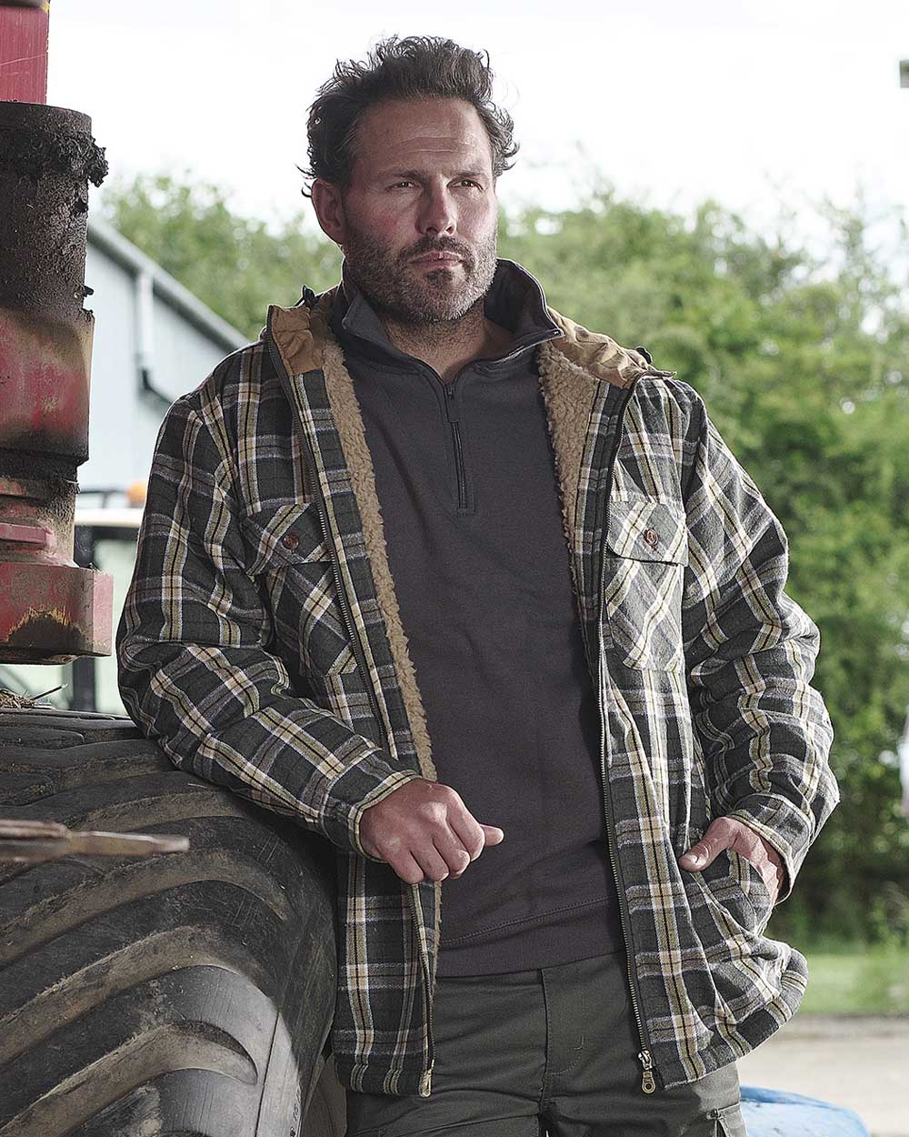 Green coloured Fort Penarth Sherpa Fleece Lined Tartan Hoodie on blurry background