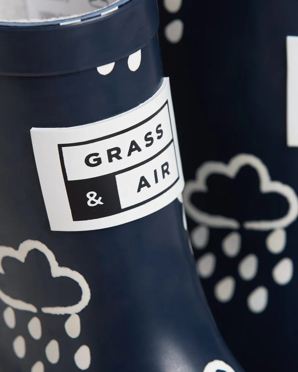 Navy coloured Grass & Air Childrens Colour-Revealing Wellies on white table background