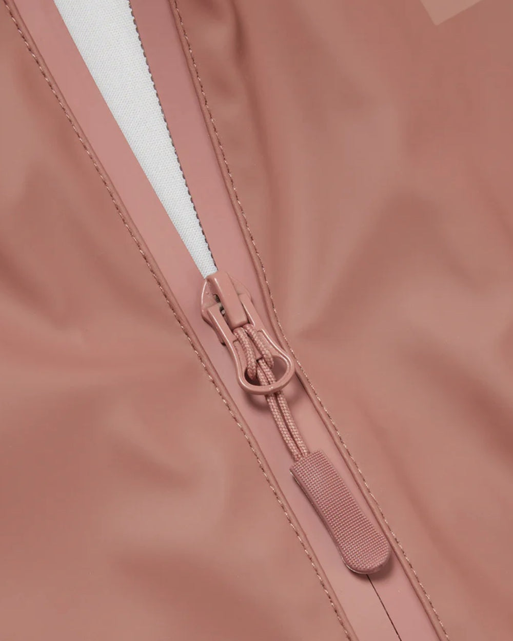 Rose coloured Grass & Air Childrens Puddle Suit on white background