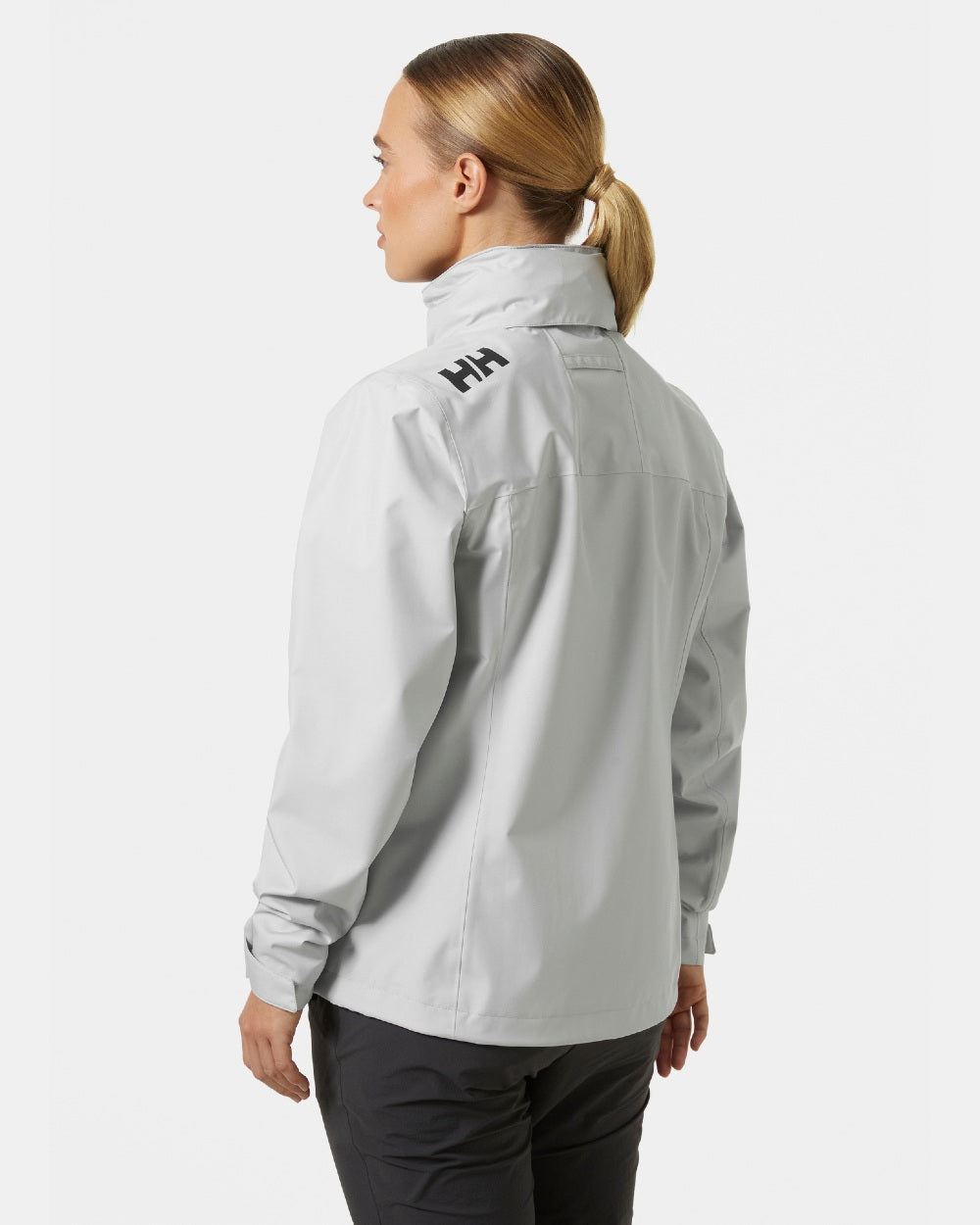 Grey Fog coloured Helly Hansen womens crew hooded sailing jacket 2.0 on grey background