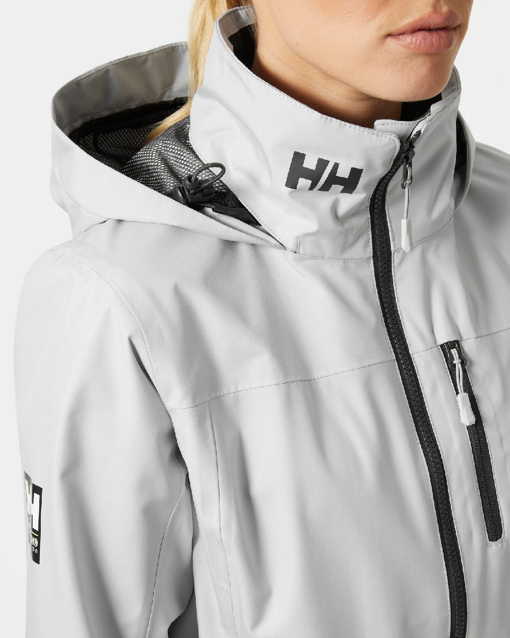 Grey Fog coloured Helly Hansen womens crew hooded sailing jacket 2.0 on grey background 