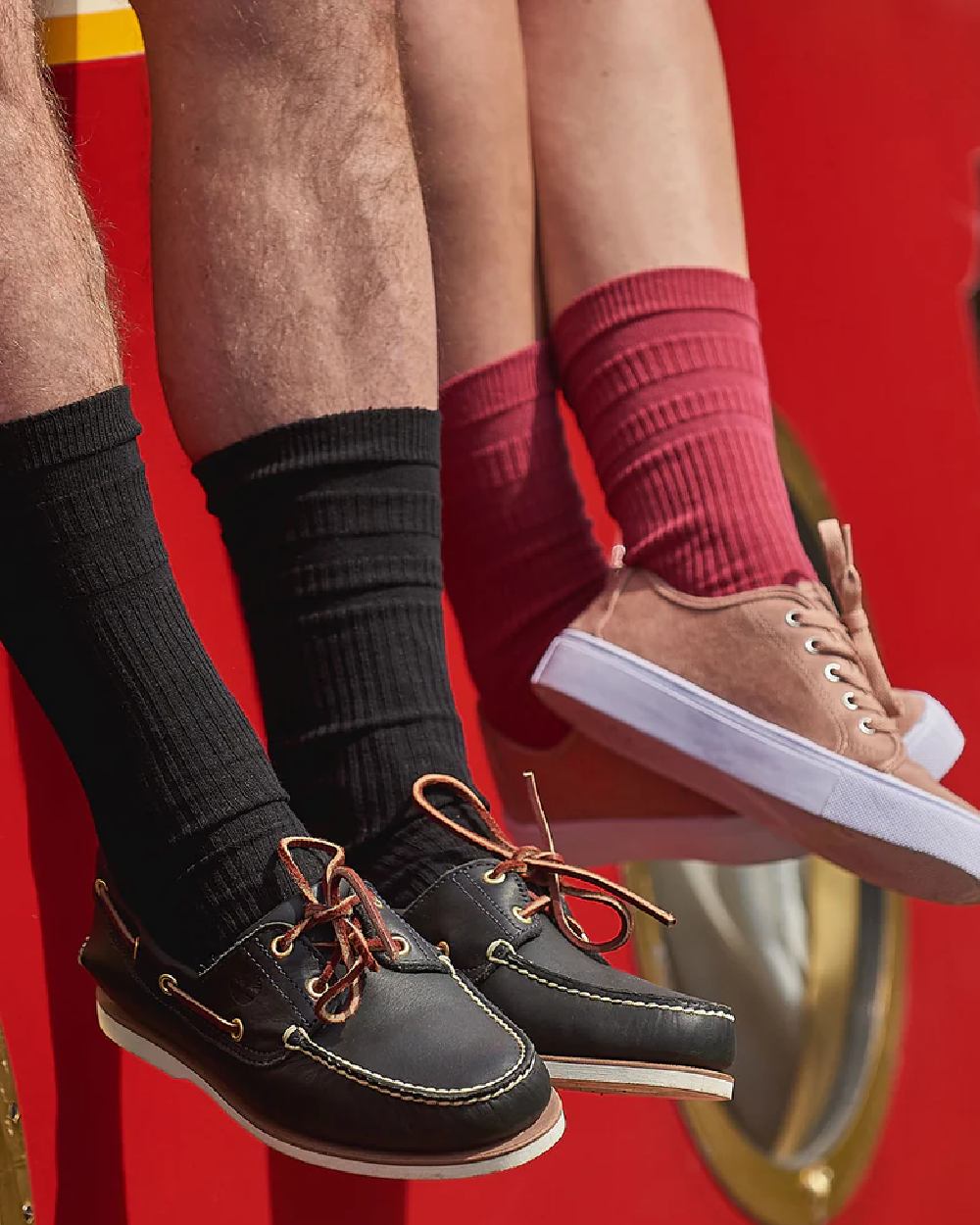 Black coloured HJ Hall Original Cotton Soft Top Socks on red background