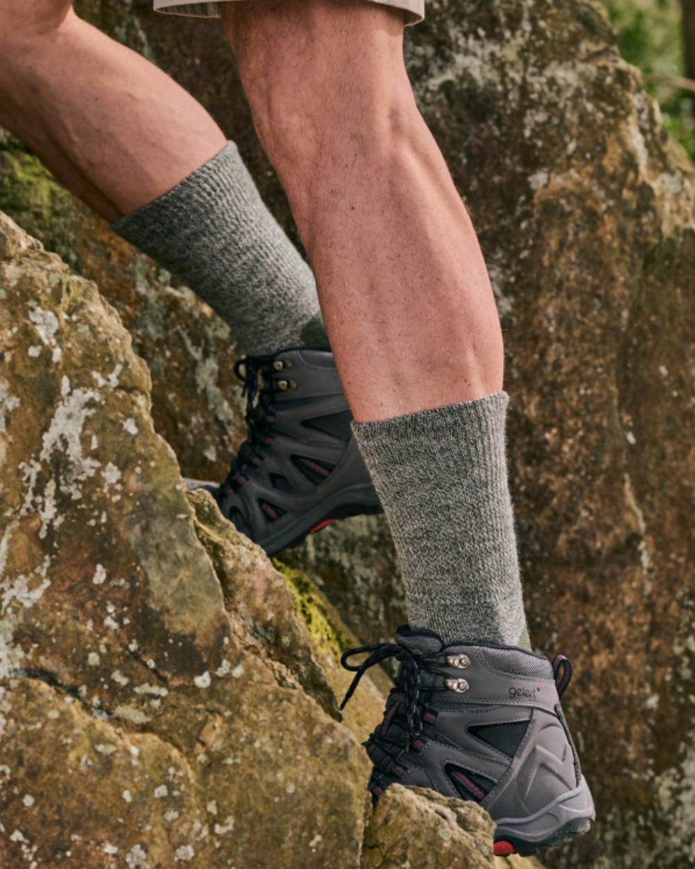Green coloured HJ Hall Technical Rambler Comfort Top Thermal Wool Socks on mountain background