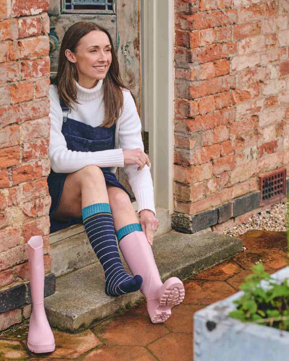 Navy coloured HJ Hall Womens Stripe Welly Socks on house background