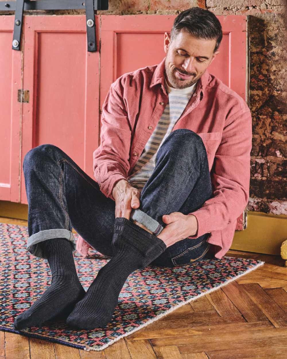 Black coloured HJ Hall Mens Original Bamboo Softop Socks on house background