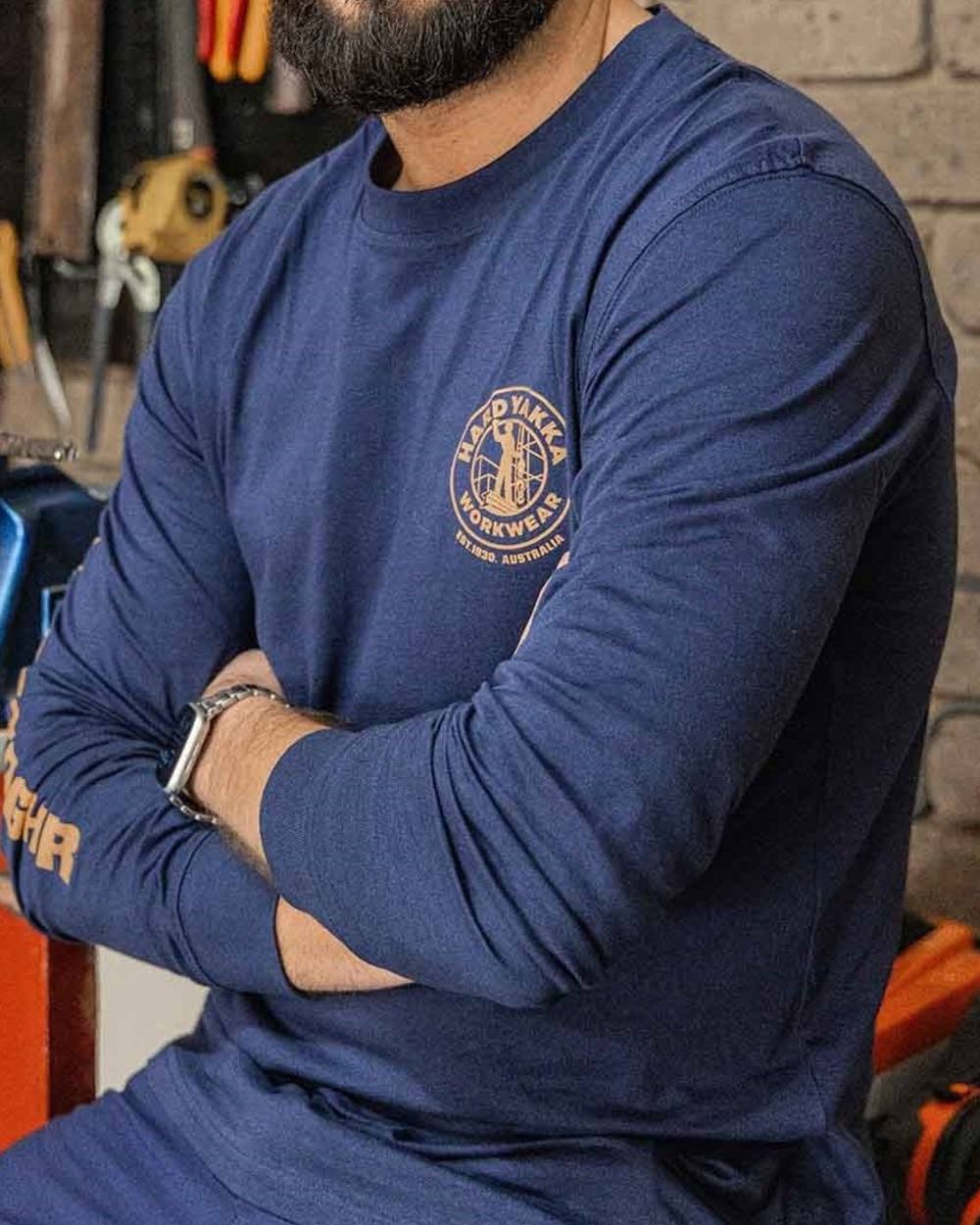 Navy coloured Hard Yakka Heritage Long Sleeve T-Shirt on outdoor background