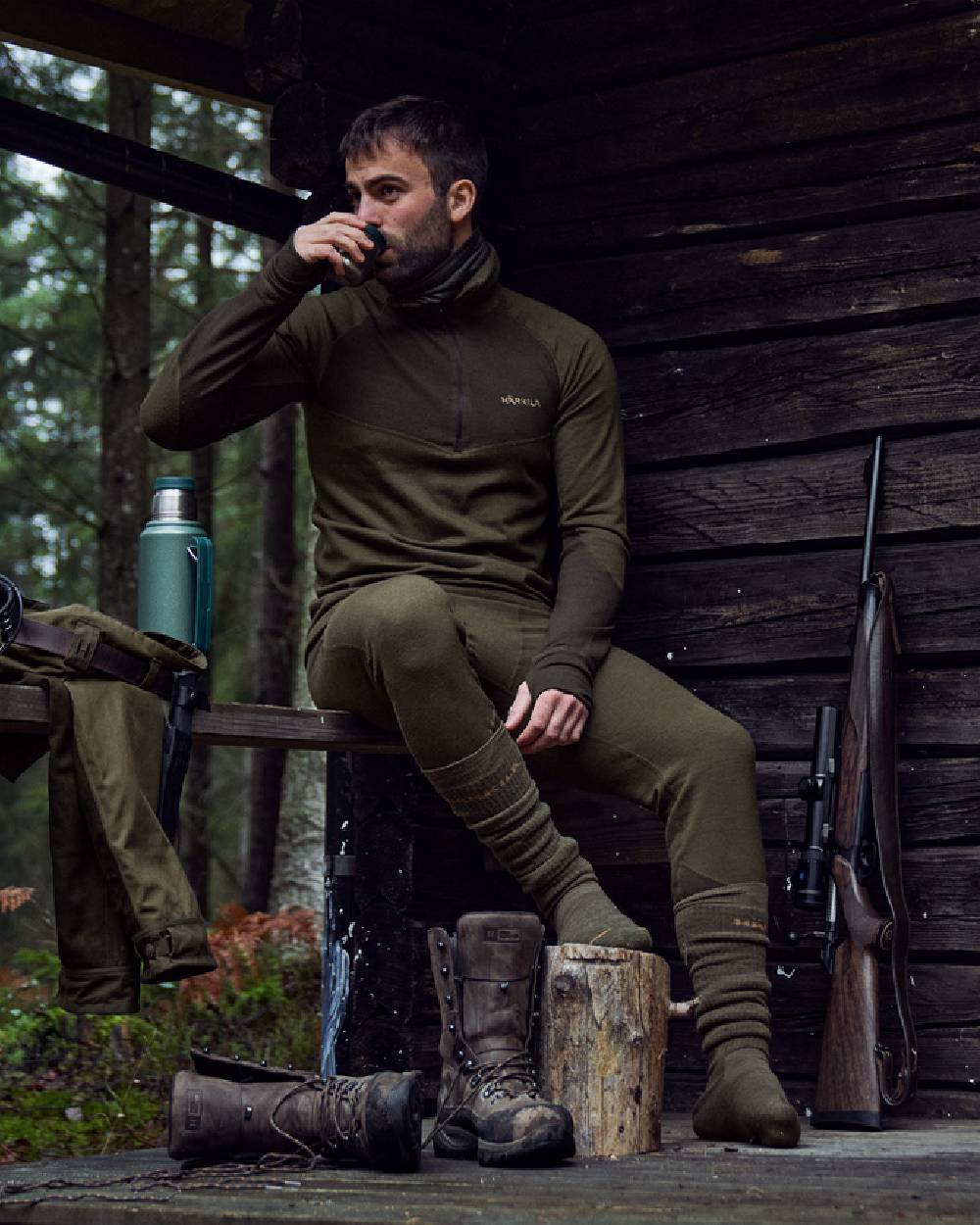 Willow Green Shadow Brown Coloured Harkila Base Warm Zip Neck on countryside background