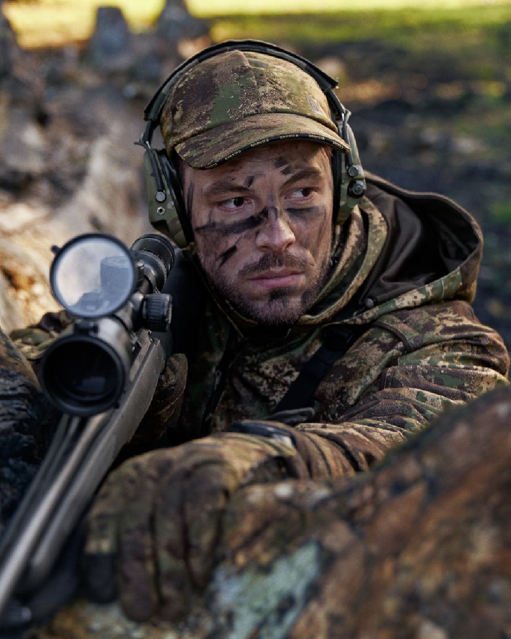 AXIS Forest Coloured Harkila Deer Stalker Camo HWS Cap on blurry background