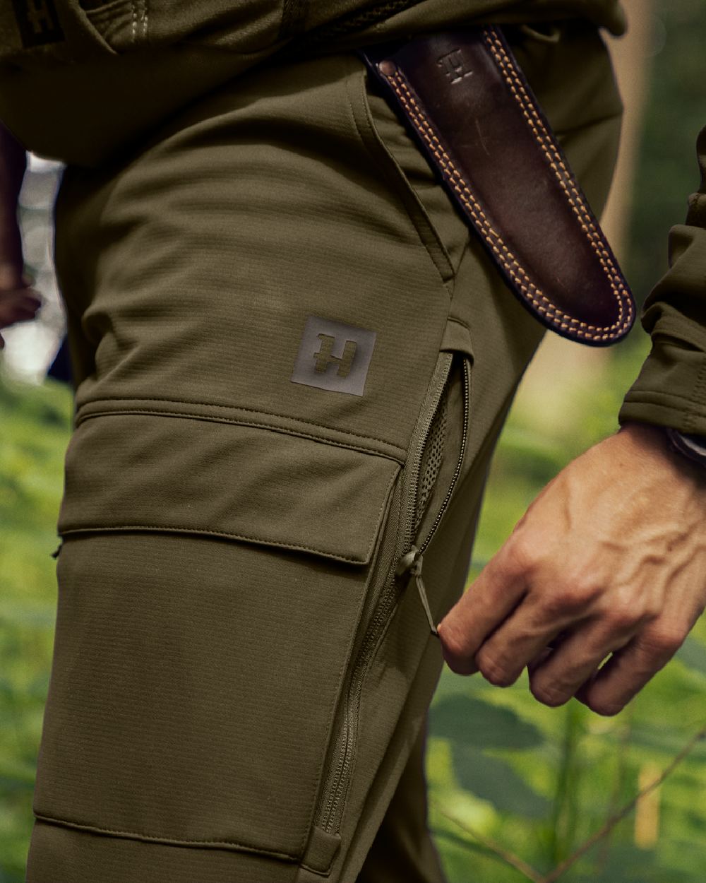 Willow Green Shadow Brown Coloured Harkila Deer Stalker Light Trousers on outdoor background