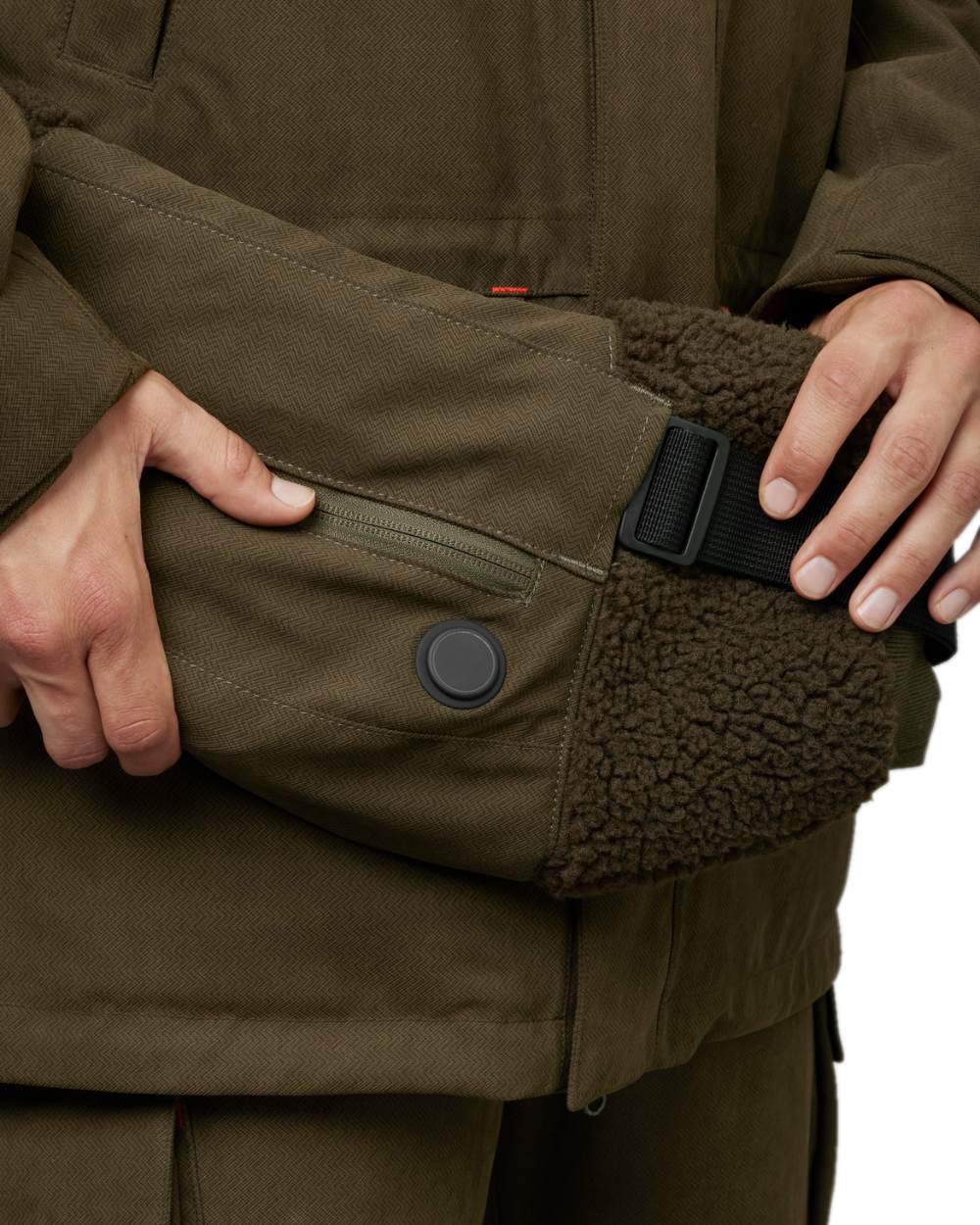 Willow Green Coloured Harkila Driven Hunt Heat Muff on white background