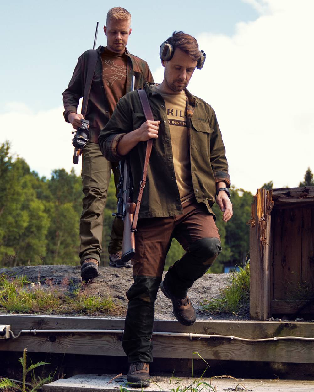 Dark Warm Olive Burgundy Coloured Harkila Eirik Reversible Shirt Jacket on countryside background