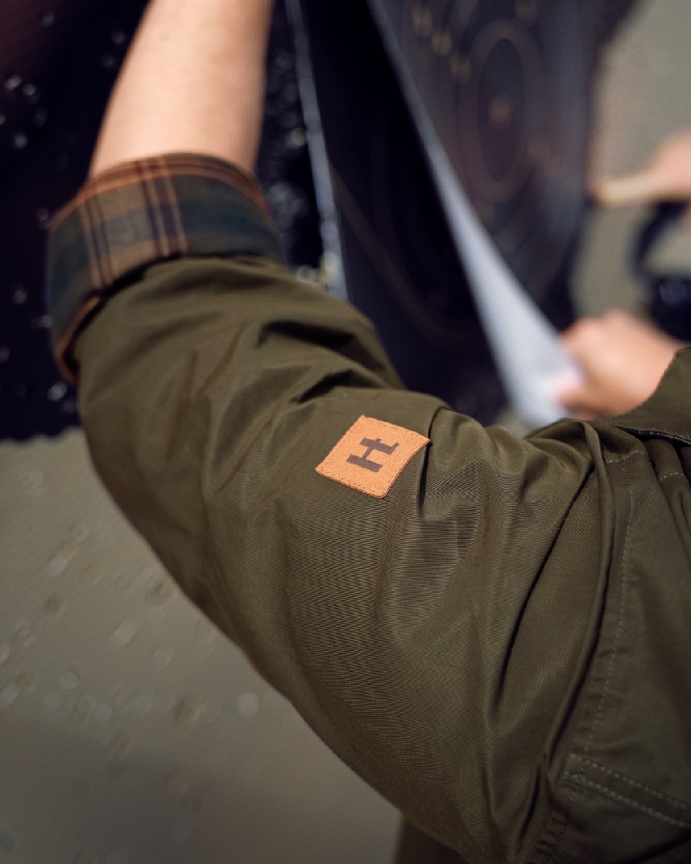 Dark Warm Olive Burgundy Coloured Harkila Eirik Reversible Shirt Jacket on blurry background