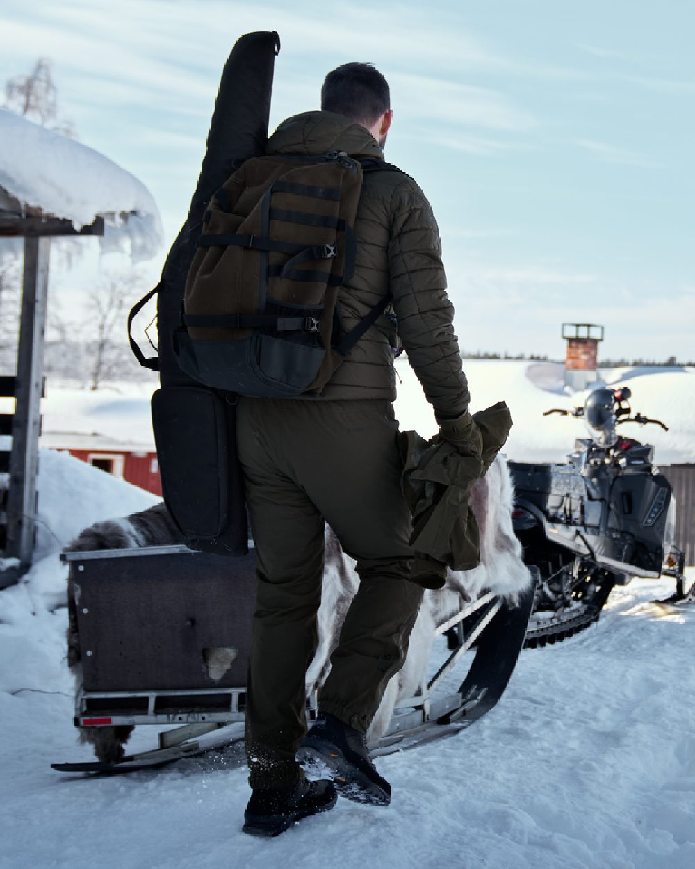 Hunting Green Coloured Harkila Forest Hunter Backpack on snow background