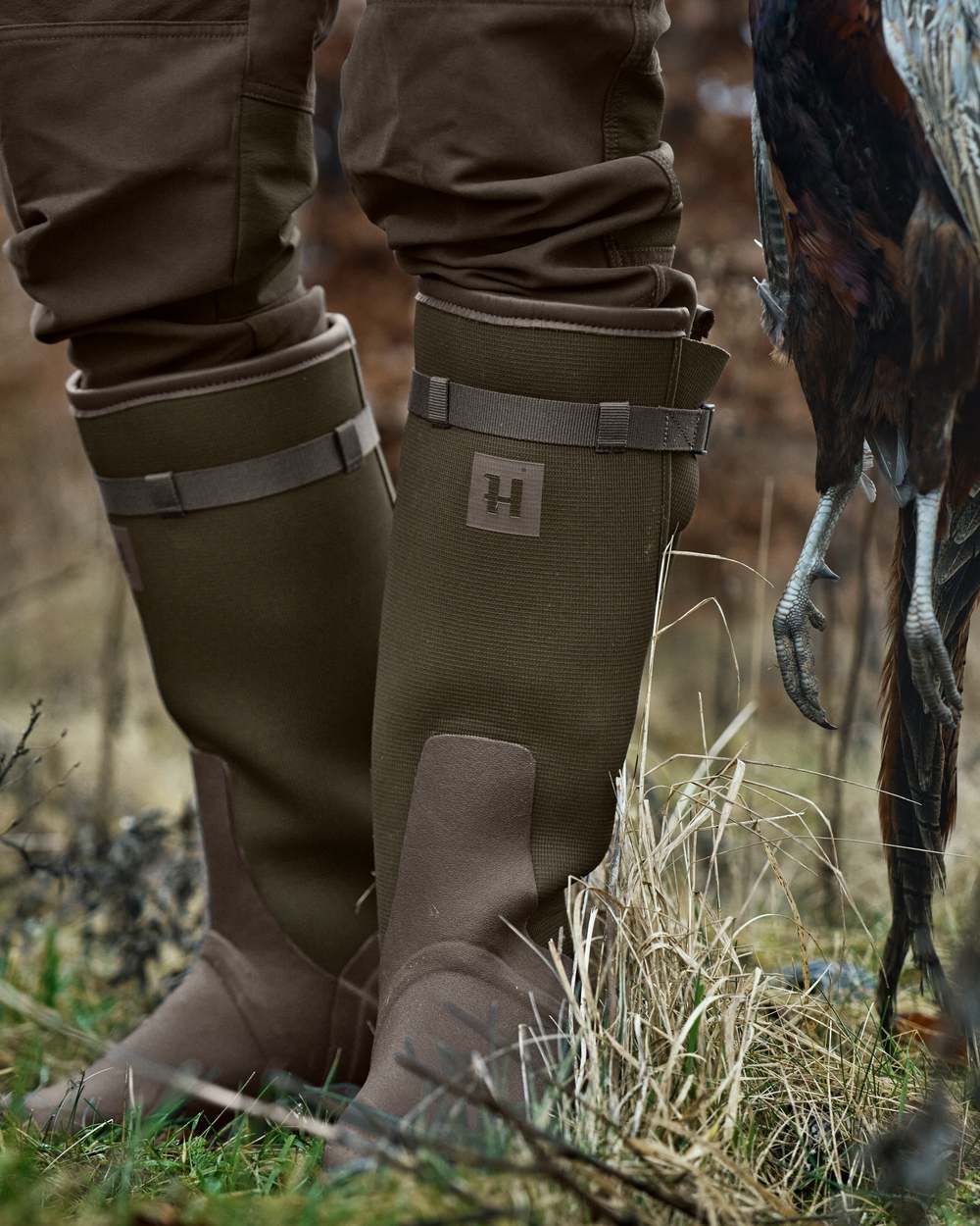 Willow Green Deep Brown Coloured Harkila Forester Zip Rubber Boot on outdoor background